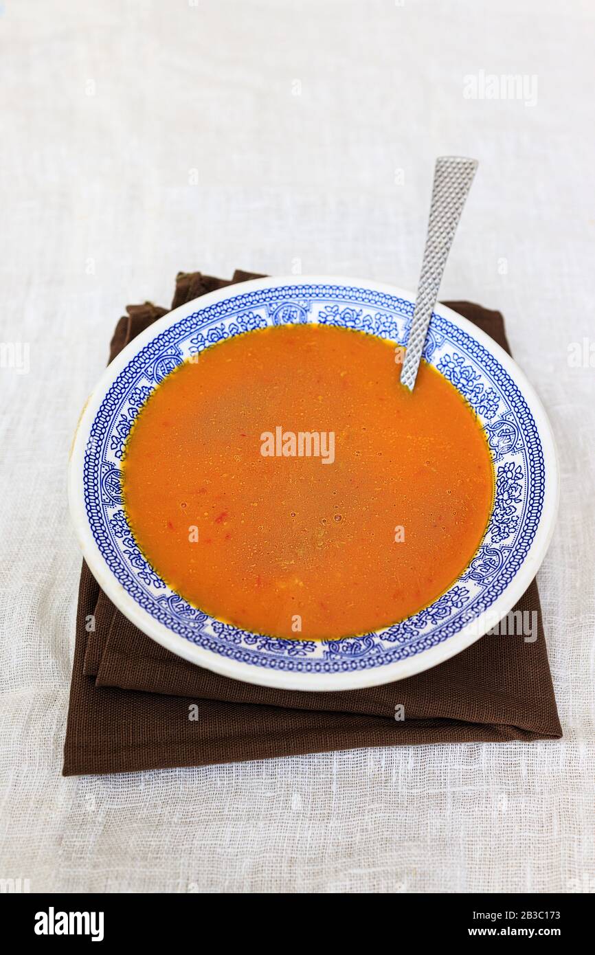 Orange pumpkin puree in a plate with a blue traditional pattern on a plain white background. copy space. Stock Photo