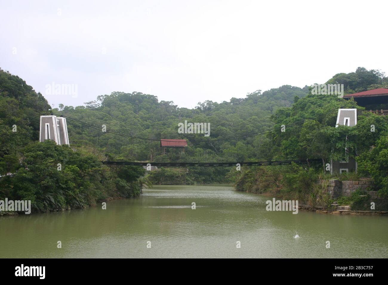 Overcast view of the Lovers Lake Suspension Bridge at Keelung, Taiwan Stock Photo