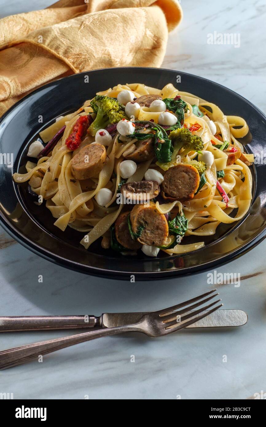 Italian chicken sausage fettuccine primavera in a garlic white wine