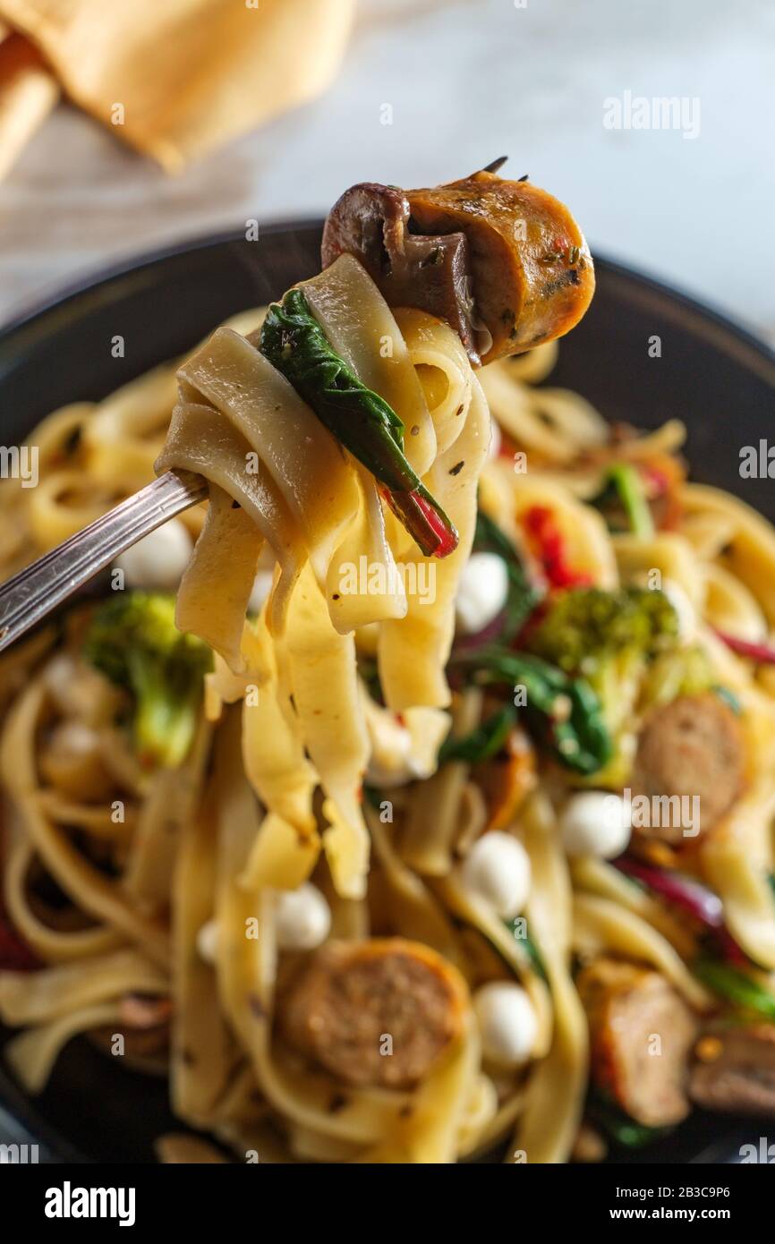 Italian chicken sausage fettuccine primavera in a garlic white wine