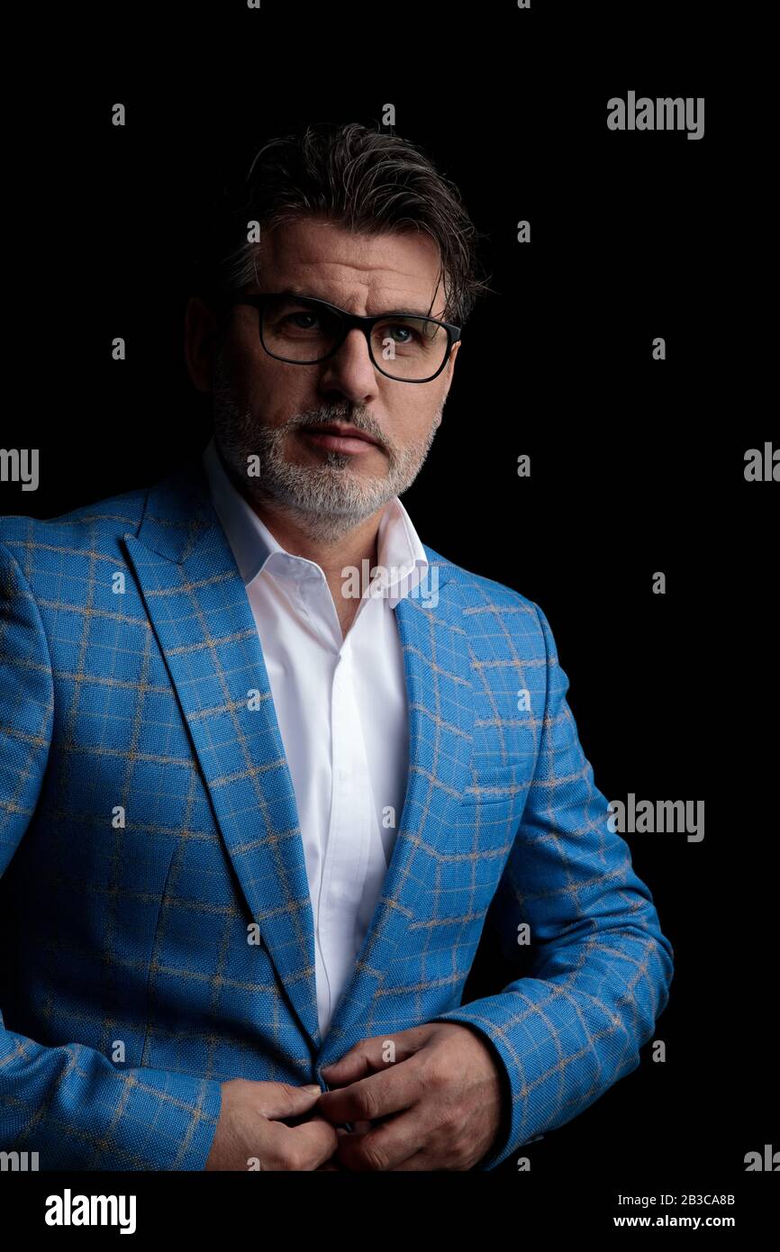 attractive formal business man wearing blue suit and glasses standing ...
