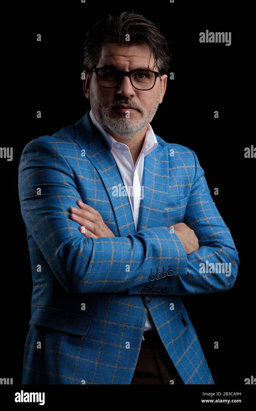 charming formal business man wearing blue suit and glasses standing ...