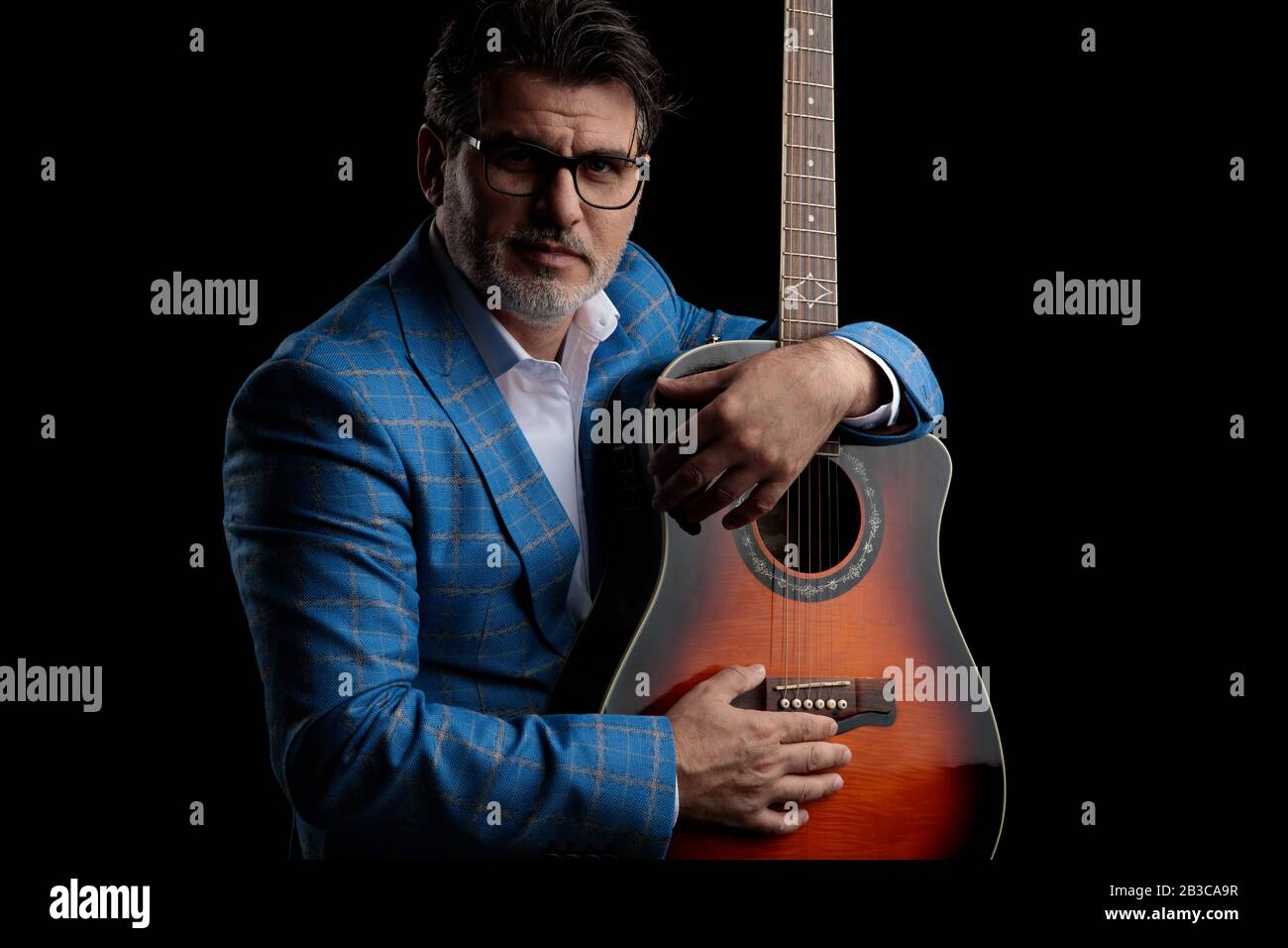 good looking formal business man wearing blue suit and glasses sitting ...