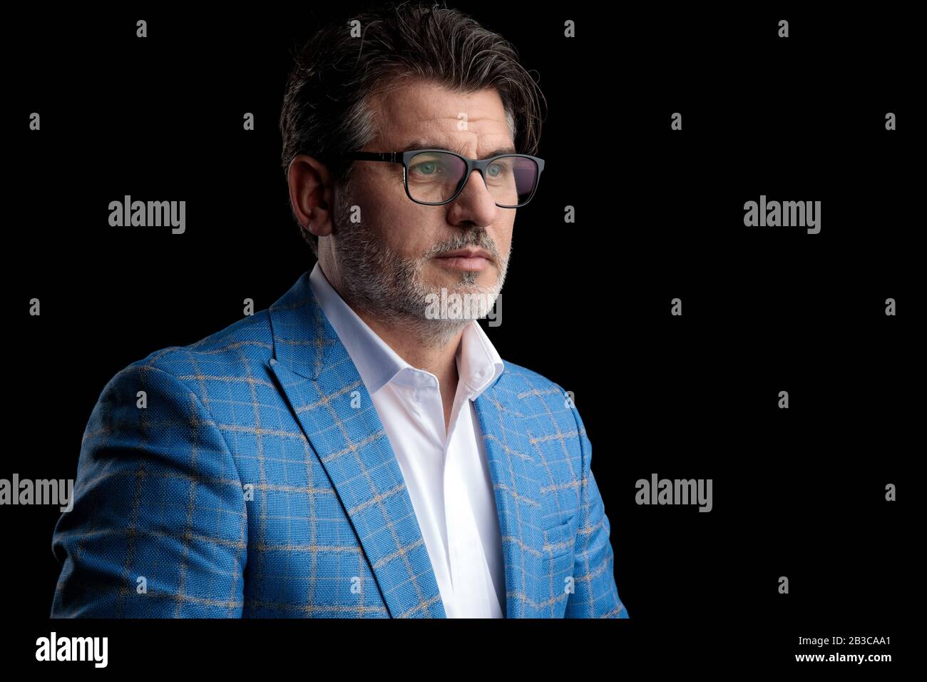 side view of a fine formal business man wearing blue suit and glasses ...