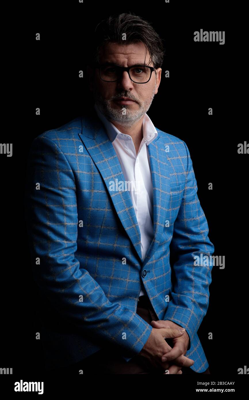old formal business man wearing blue suit and glasses standing and ...