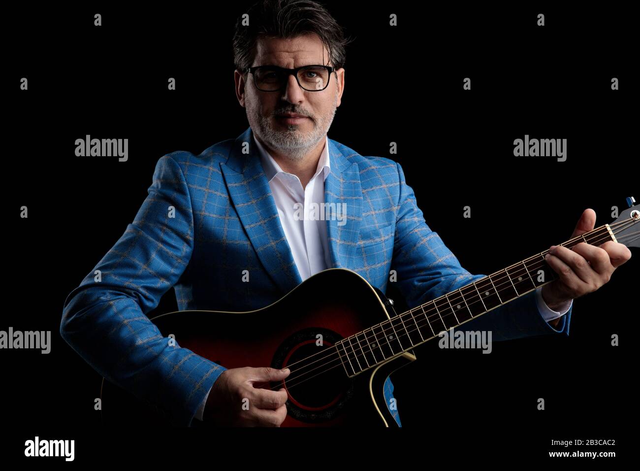gorgeous formal business man wearing blue suit and glasses standing and ...