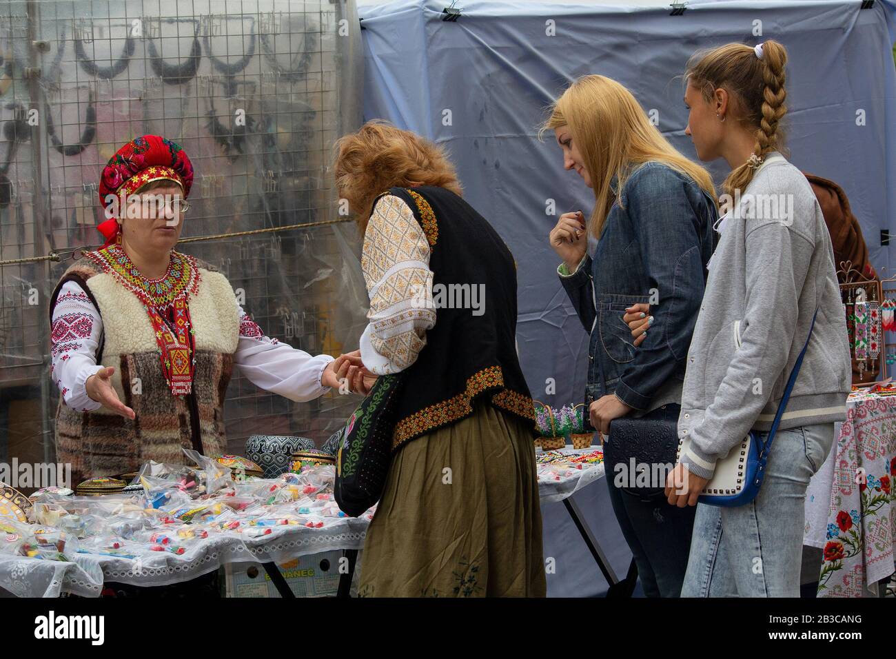 Kiev, Ukraine - August 24, 2016: Woman in embroidery sells souvenirs on the street St. Andrew's descent - the historic center of the city Stock Photo