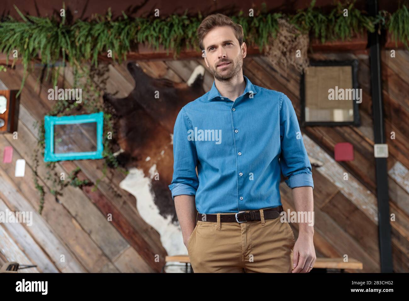 a man in a blue polo shirt and brown pants. AI-Generated 33638613 Stock  Photo at Vecteezy