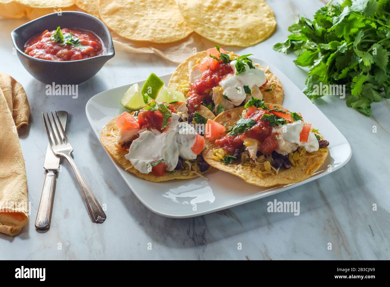 Mexican chicken tostada flat tacos with rice black beans salsa and sour