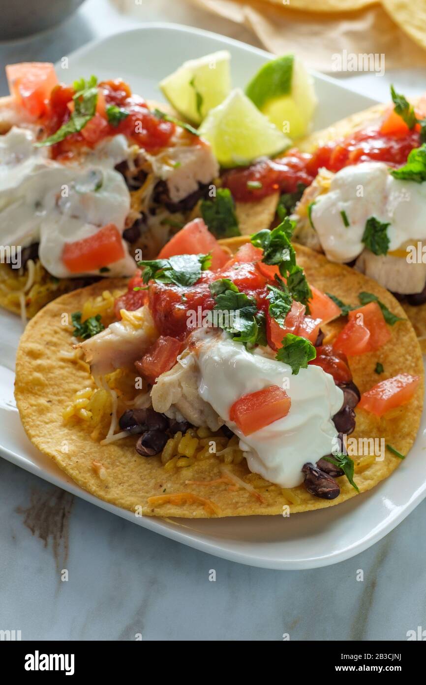 Mexican chicken tostada flat tacos with rice black beans salsa and sour