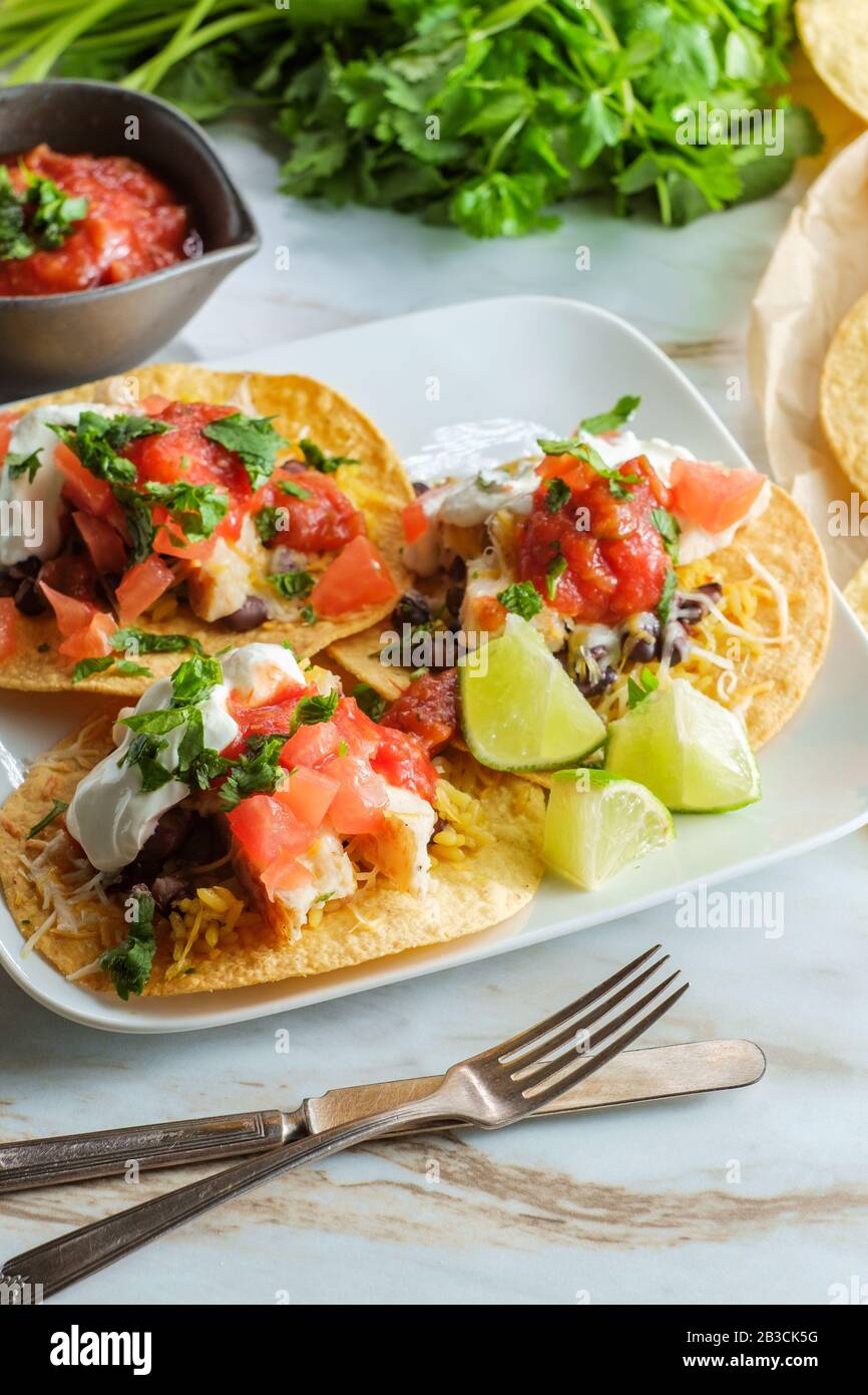 Mexican chicken tostada flat tacos with rice black beans salsa and sour