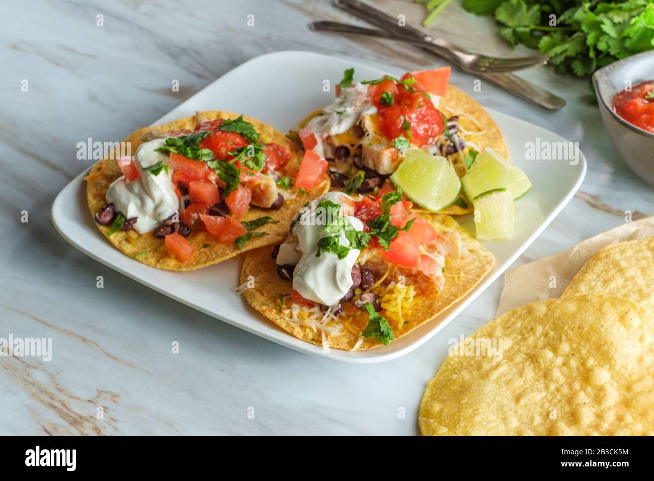 Mexican chicken tostada flat tacos with rice black beans salsa and sour