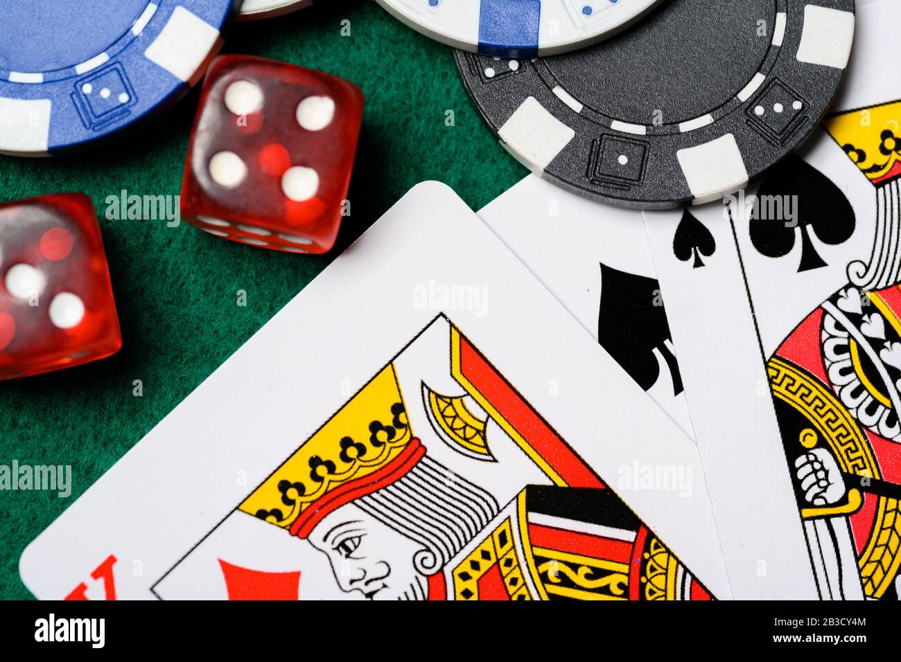 Poker chips, playing cards and dice on a green backgrorund. gambling Stock Photo
