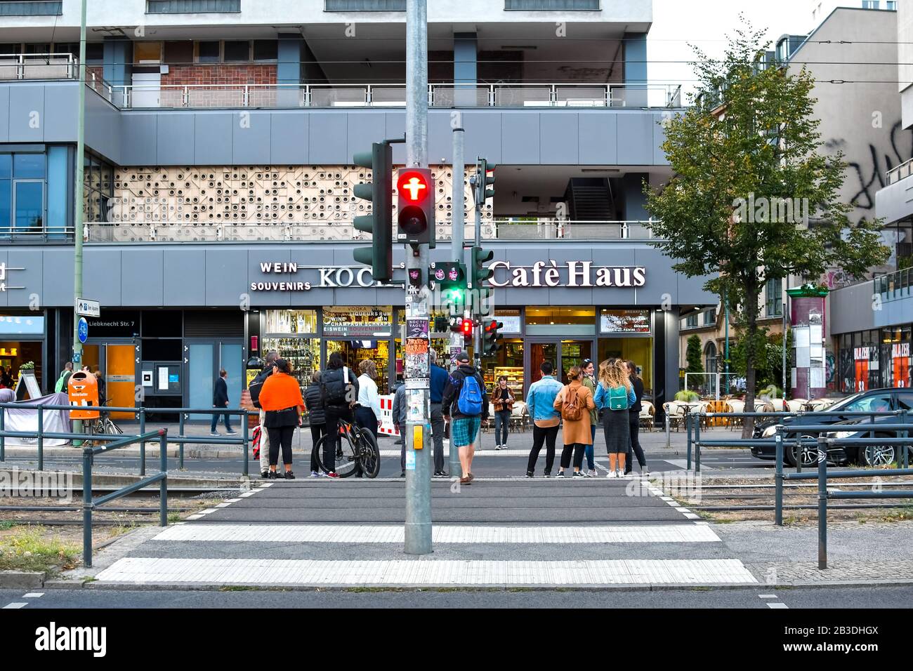 Germans wait at an intersection crosswalk in the urban center of the Mitte District in Berlin Germany. Stock Photo