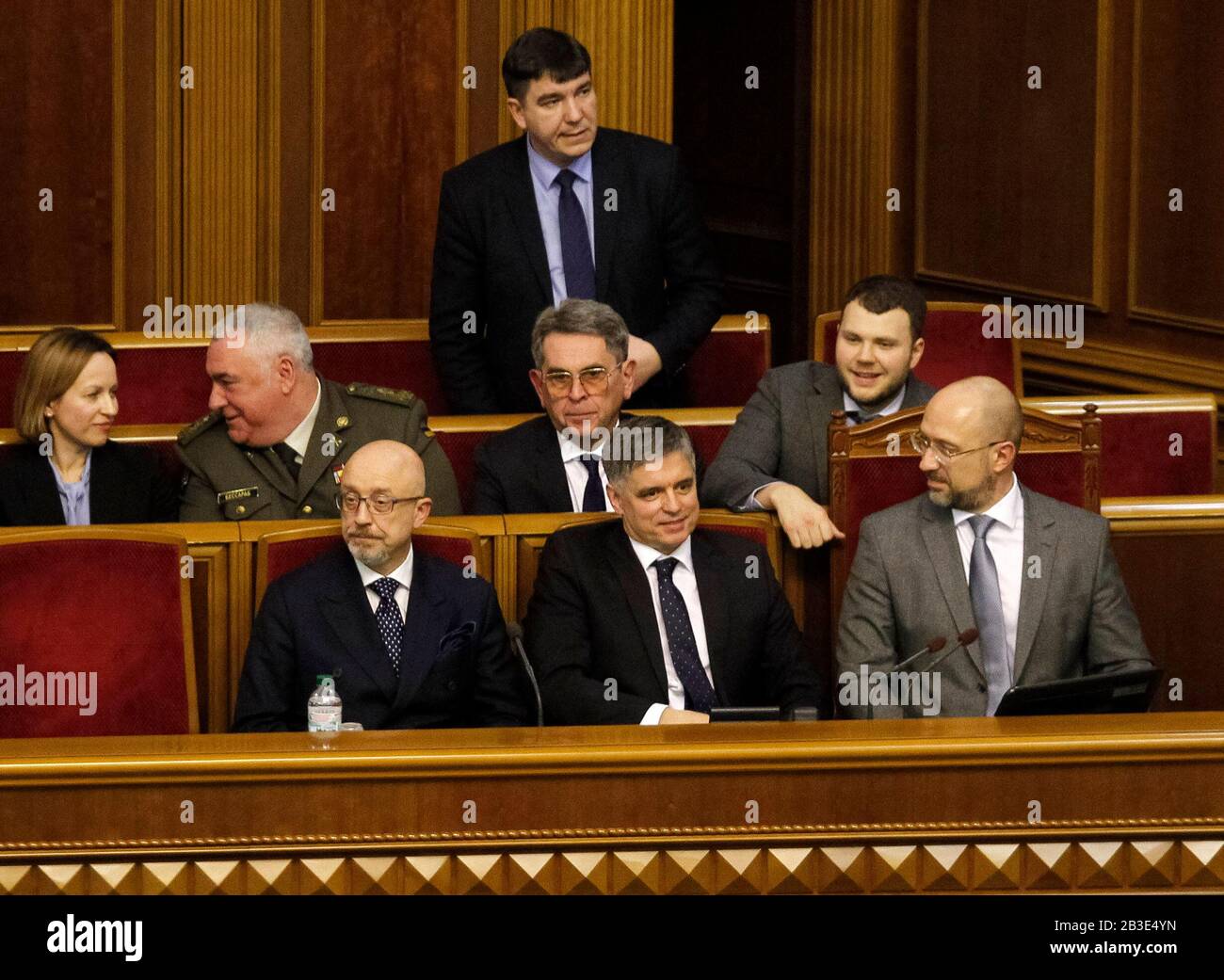 Kiev, Ukraine. 4th Mar, 2020. Newly-appointed Ukrainian Prime Minister DENYS SHMYGAL (R) and members of the newly appointed Cabinet of Ministers react during a parliamentary session in Kiev, Ukraine, on 4 March 2020. Ukrainian Parliament supported proposal of the Ukrainian President and voted to appoint DENIS SHMYGAL as new Ukraine's Prime Minister. Credit: Serg Glovny/ZUMA Wire/Alamy Live News Stock Photo