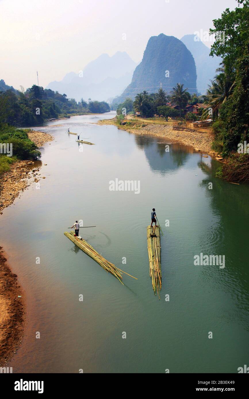 people rowing on bamboo raft in asian river Stock Photo - Alamy