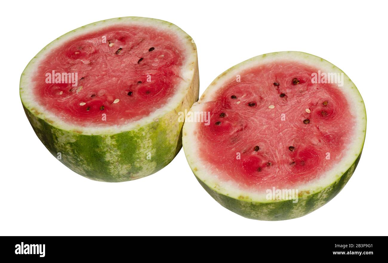 A juicy, red ripe watermelon (Citrullus lanatus) is cut in half and is isolated on a white background Stock Photo