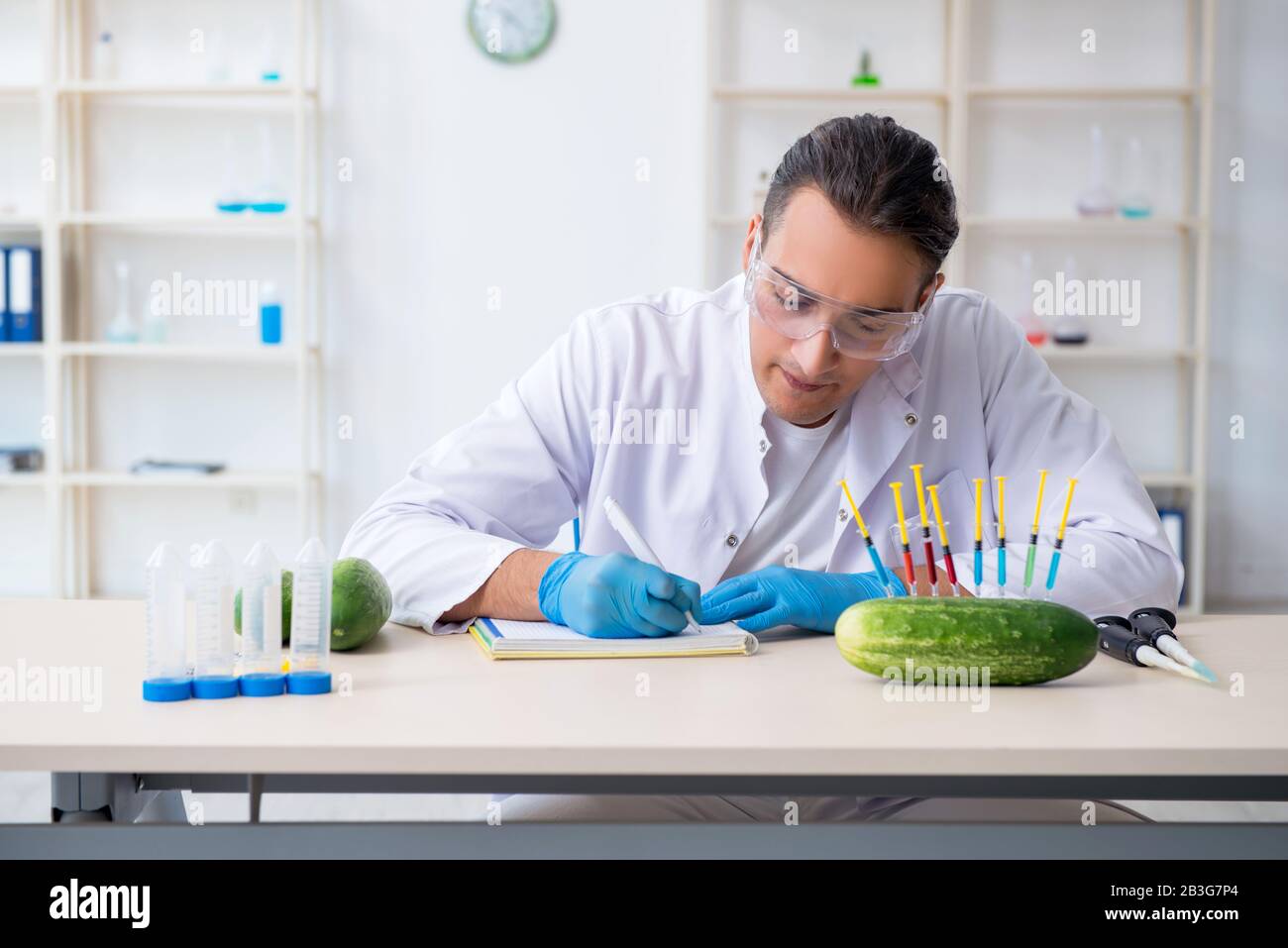 The male nutrition expert testing vegetables in lab Stock Photo - Alamy