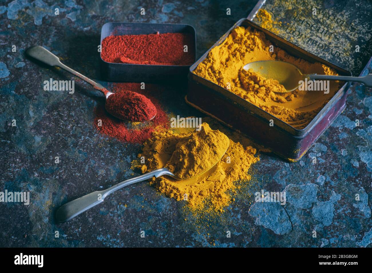 Turmeric and Paprika powder. Aromatic spices in tins on a slate background Stock Photo