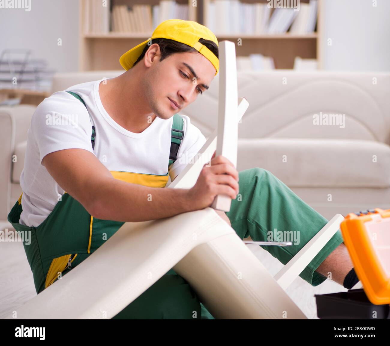 The furniture repairman repairing armchair at home Stock Photo Alamy