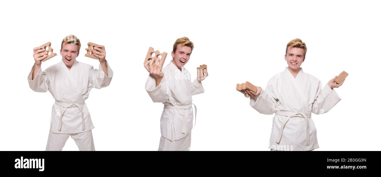 The funny karate man breaking bricks isolated on white Stock Photo