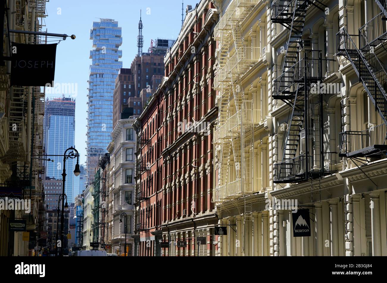 Historic cast-iron buildings in SoHo neighborhood with luxury high-rise 56 Leonard Street in Tribeca in the background.Lower Manhattan.New York City.USA Stock Photo