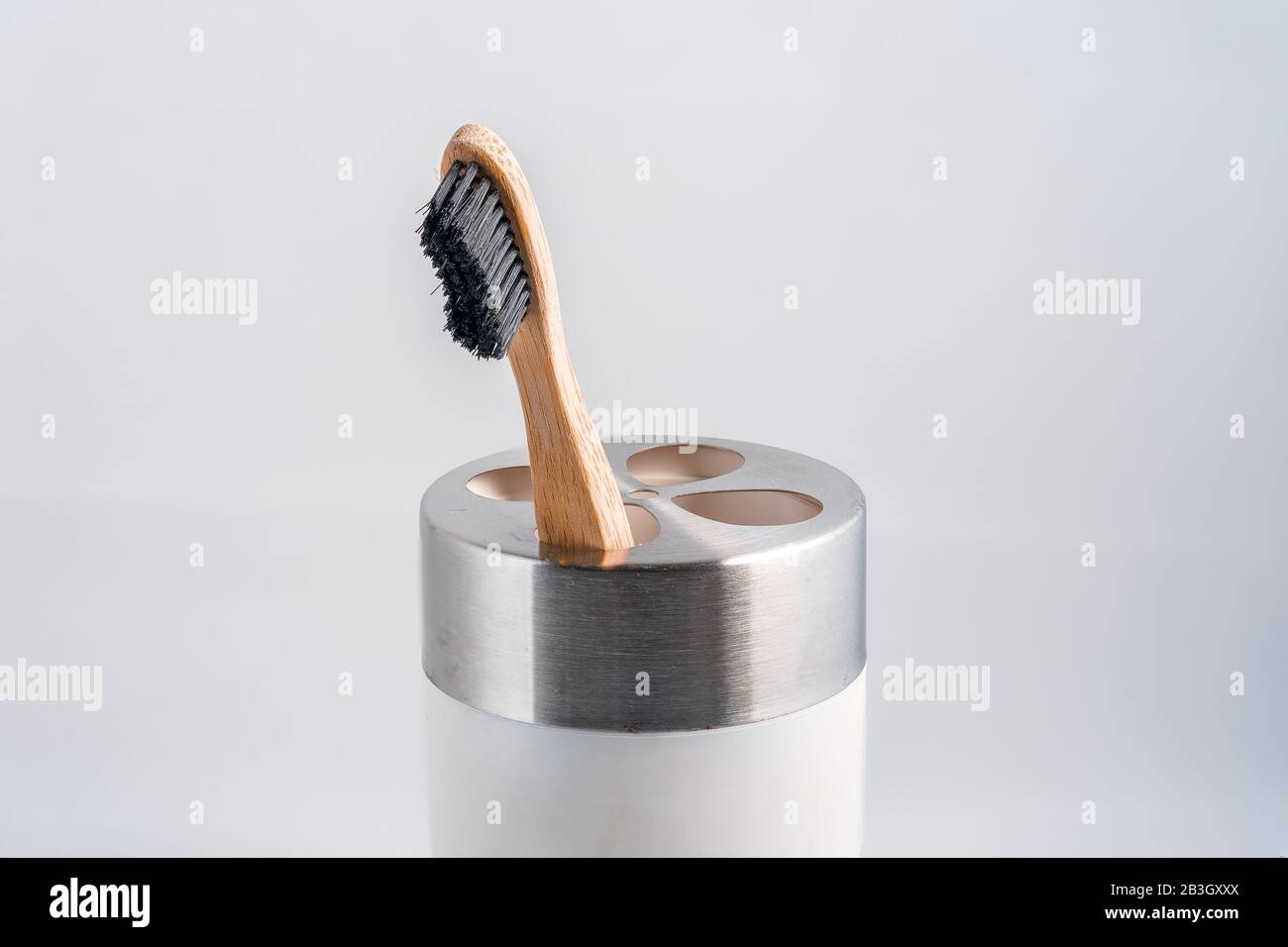 A single wooden eco-friendly toothbrush in a cup Stock Photo