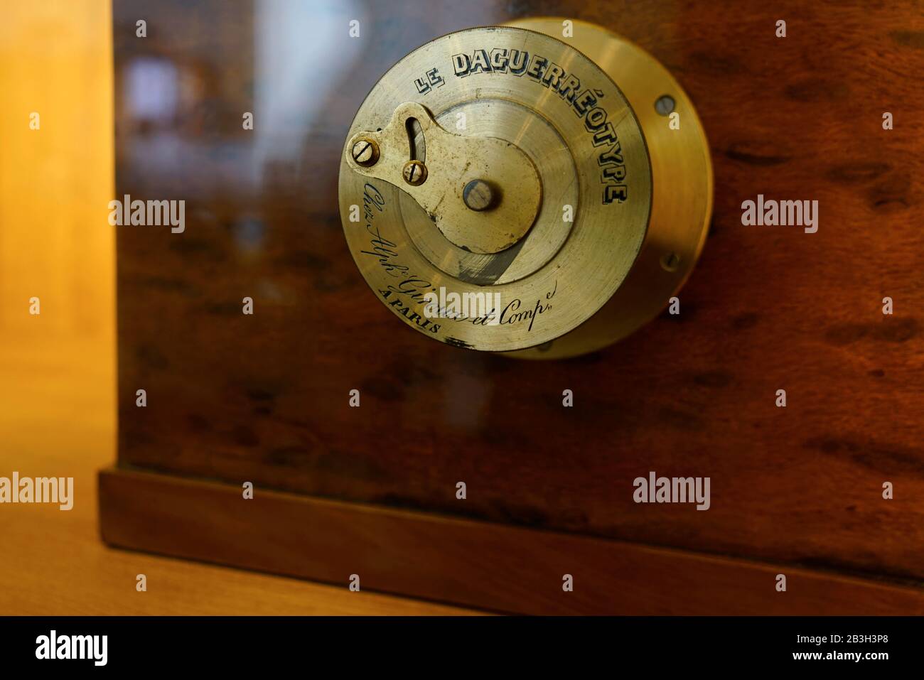 The brass lens of a sliding box camera for daguerreotype photography