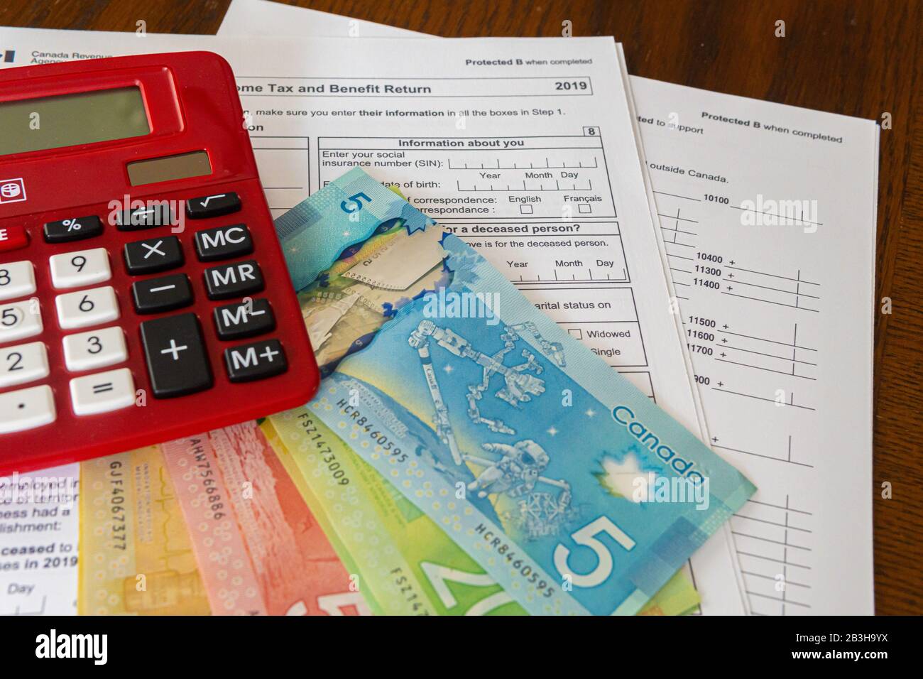 Calculator with Canadin Dollar notes and Canadian new 2019 Tax Form