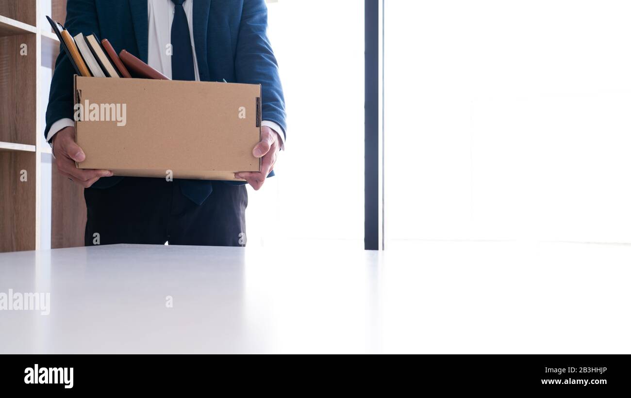 Putting Paper Businessmen are holding resignation document and packing personal ...