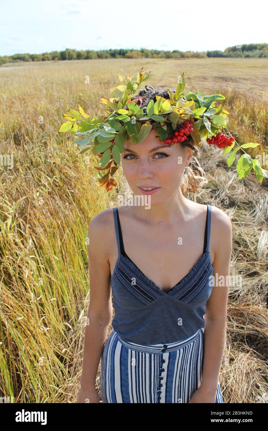 Syktyvkar, Russia - august, 2019: a young girl of slavic appearance with dreadlocks in a wreath of rowan flowers. Stock photography. Stock Photo