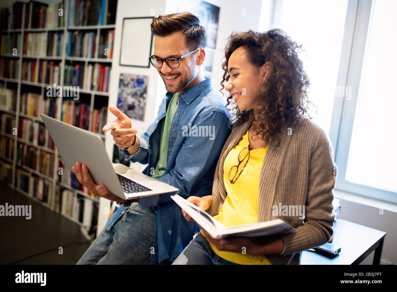 Group of college students studying in the school library. Stock Photo