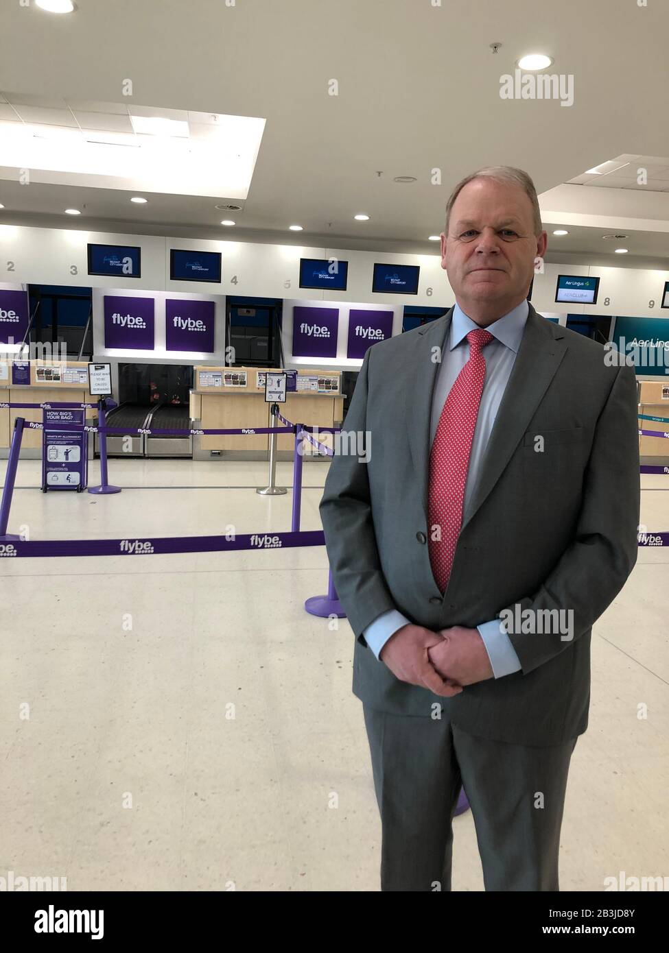 Chief executive of Belfast Airport, Brian Ambrose, speaks to the media in front of the empty Flybe check-in desks at Belfast Airport after Europe's biggest regional airline collapsed into administration. Stock Photo