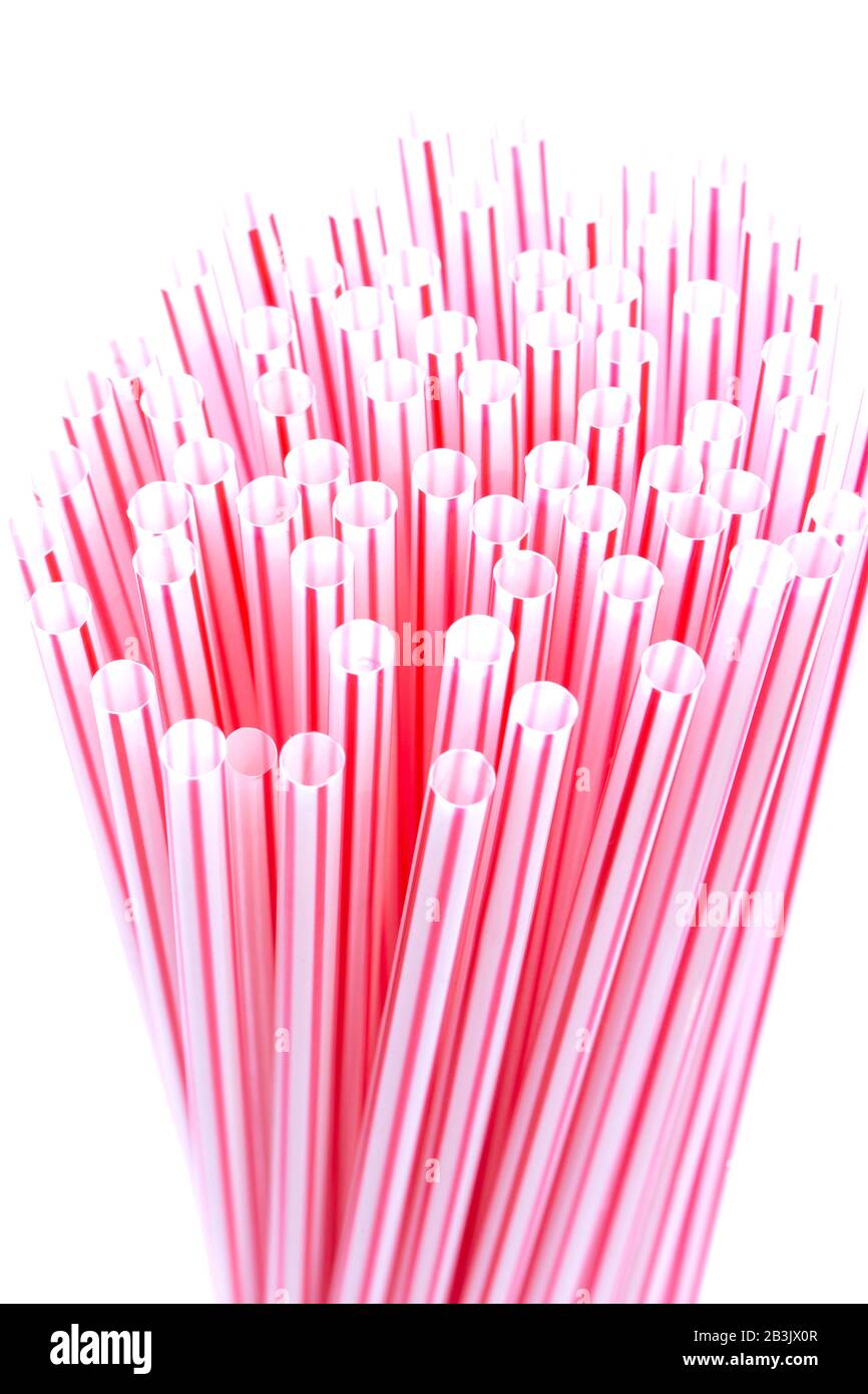 Plastic straws with red and white stripes in a bunch isolated on a