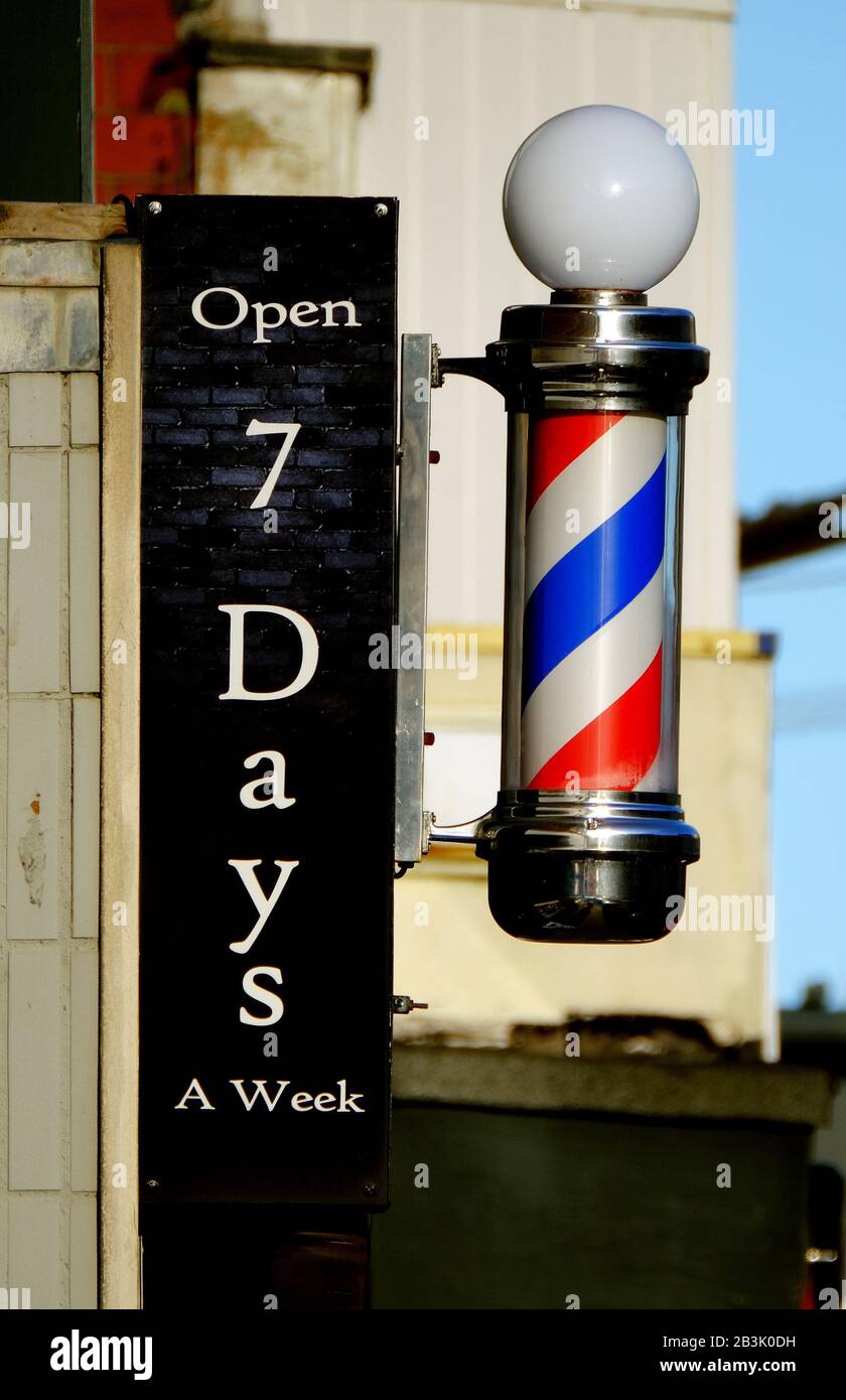 Barbers shop sign in busy shopping street. Stock Photo