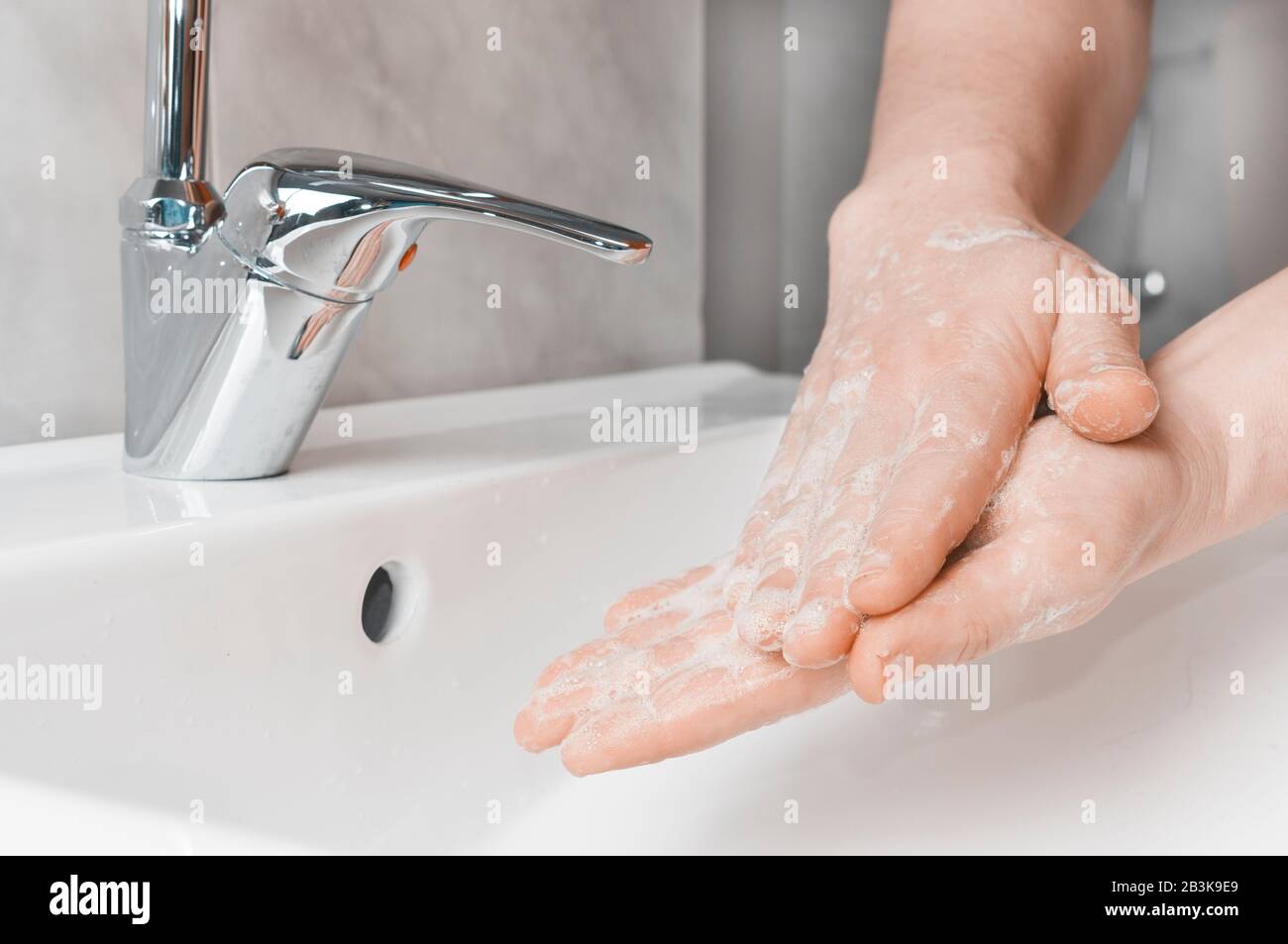 Effective handwashing tecniques: palm to palm. Hand washing is very important to avoid the risk of contagion from coronavirus and bacteria. Stock Photo