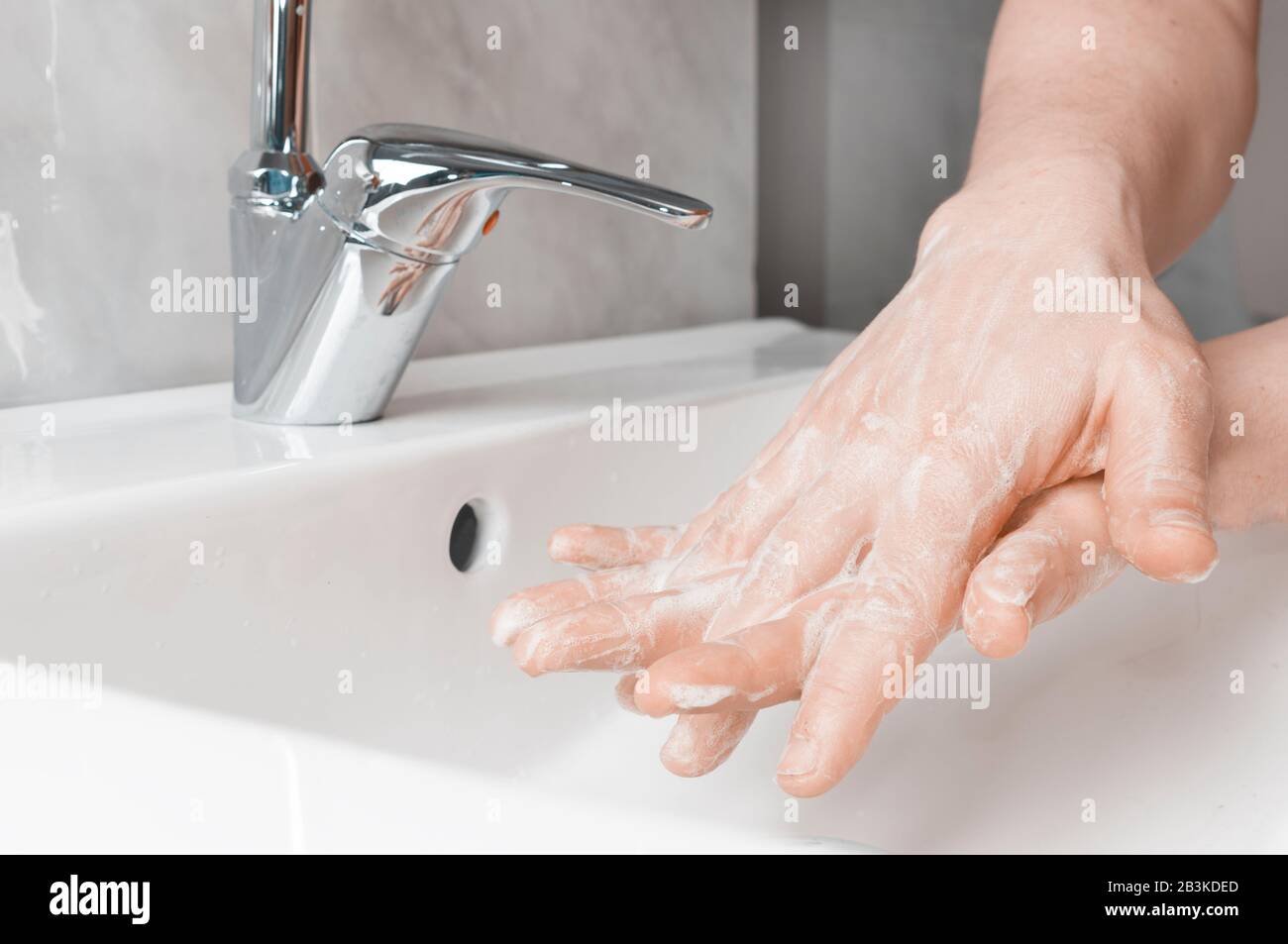 Effective handwashing techniques: between the fingers. Hand washing is very important to avoid the risk of contagion from coronavirus and bacteria. Stock Photo