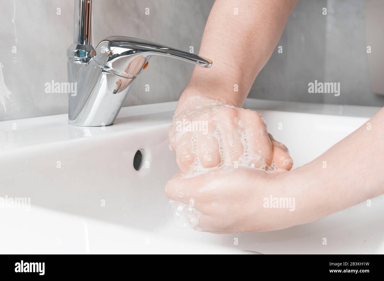 Effective handwashing techniques: rub palm with back of other hand's fingers. Hand washing is very important to avoid the risk of contagion from coron Stock Photo