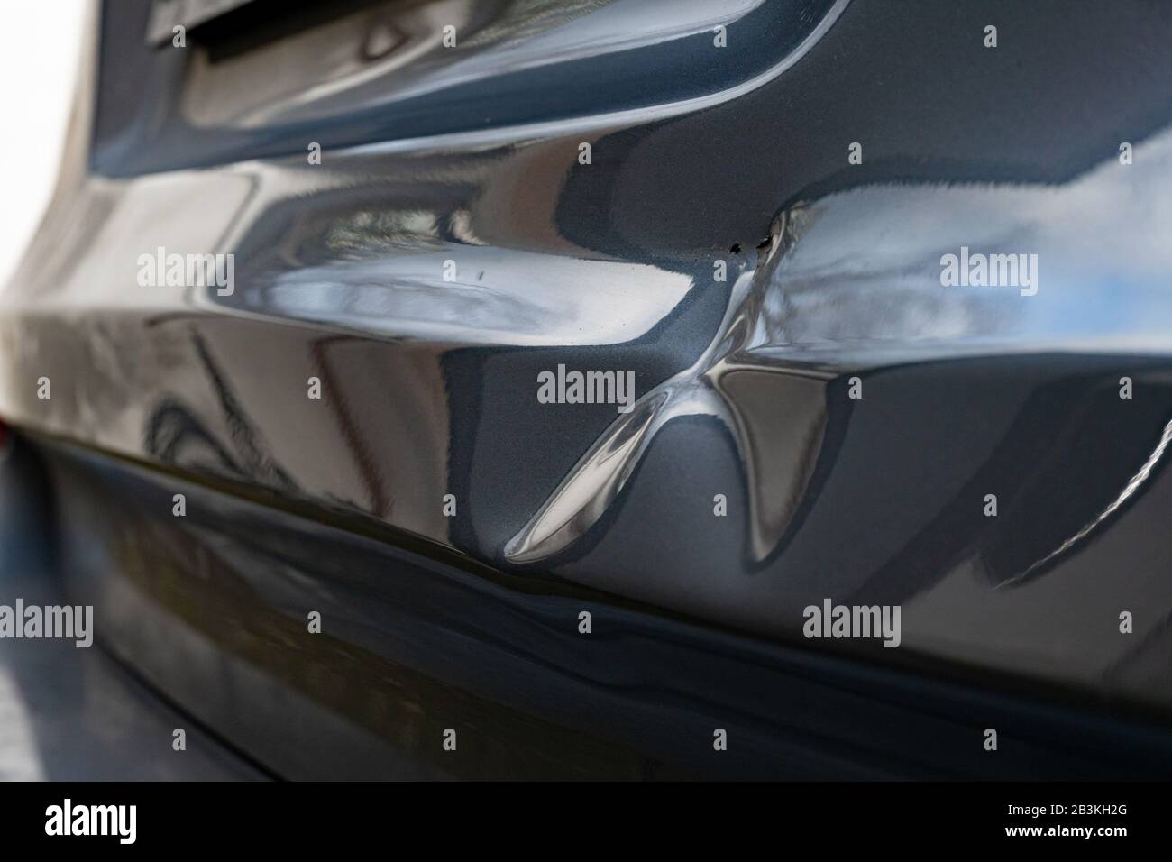 A dent in the body of a silver car Stock Photo