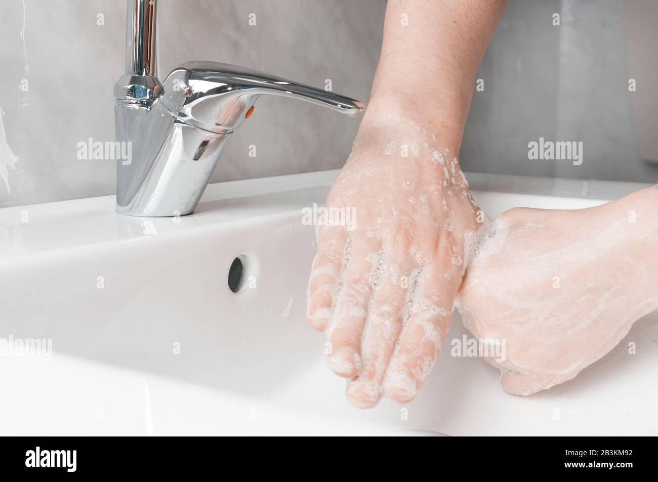 Effective handwashing techniques: rubbing each thumbs. Hand washing is very important to avoid the risk of contagion from coronavirus and bacteria. Stock Photo