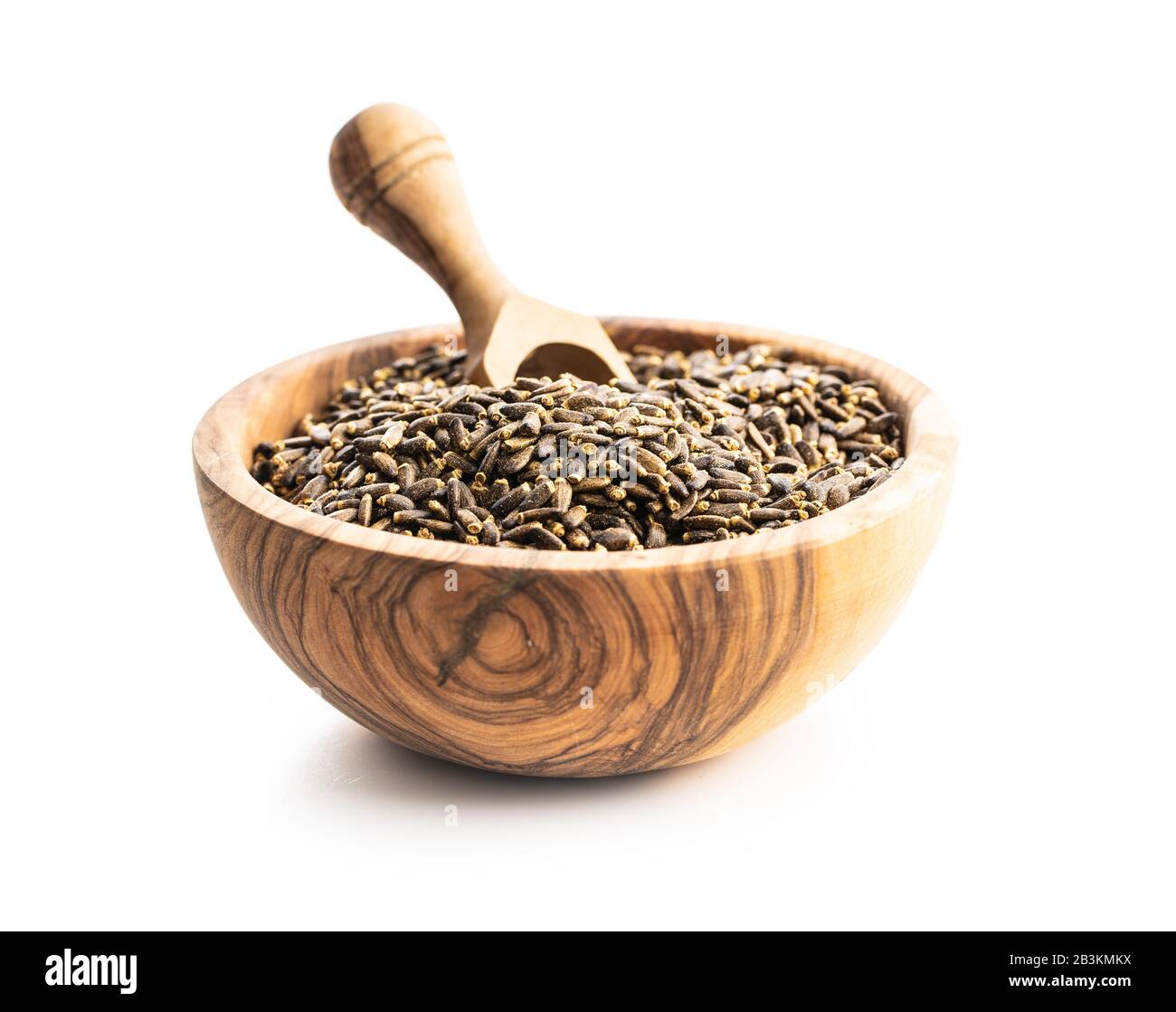 Milk thistle seeds in wooden bowl isolated on white background. Stock Photo