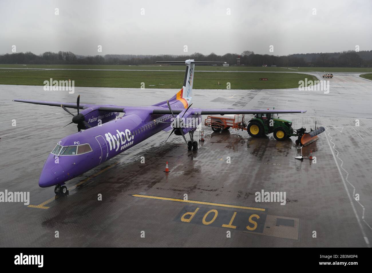A tractor blocks the wing of a Flybe plane at Southampton Airport as Flybe, Europe's biggest regional airline, has collapsed into administration. Stock Photo