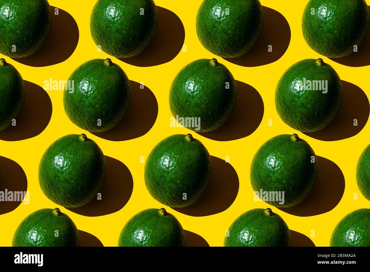 Avocado pattern on yellow background. Top view. Stock Photo