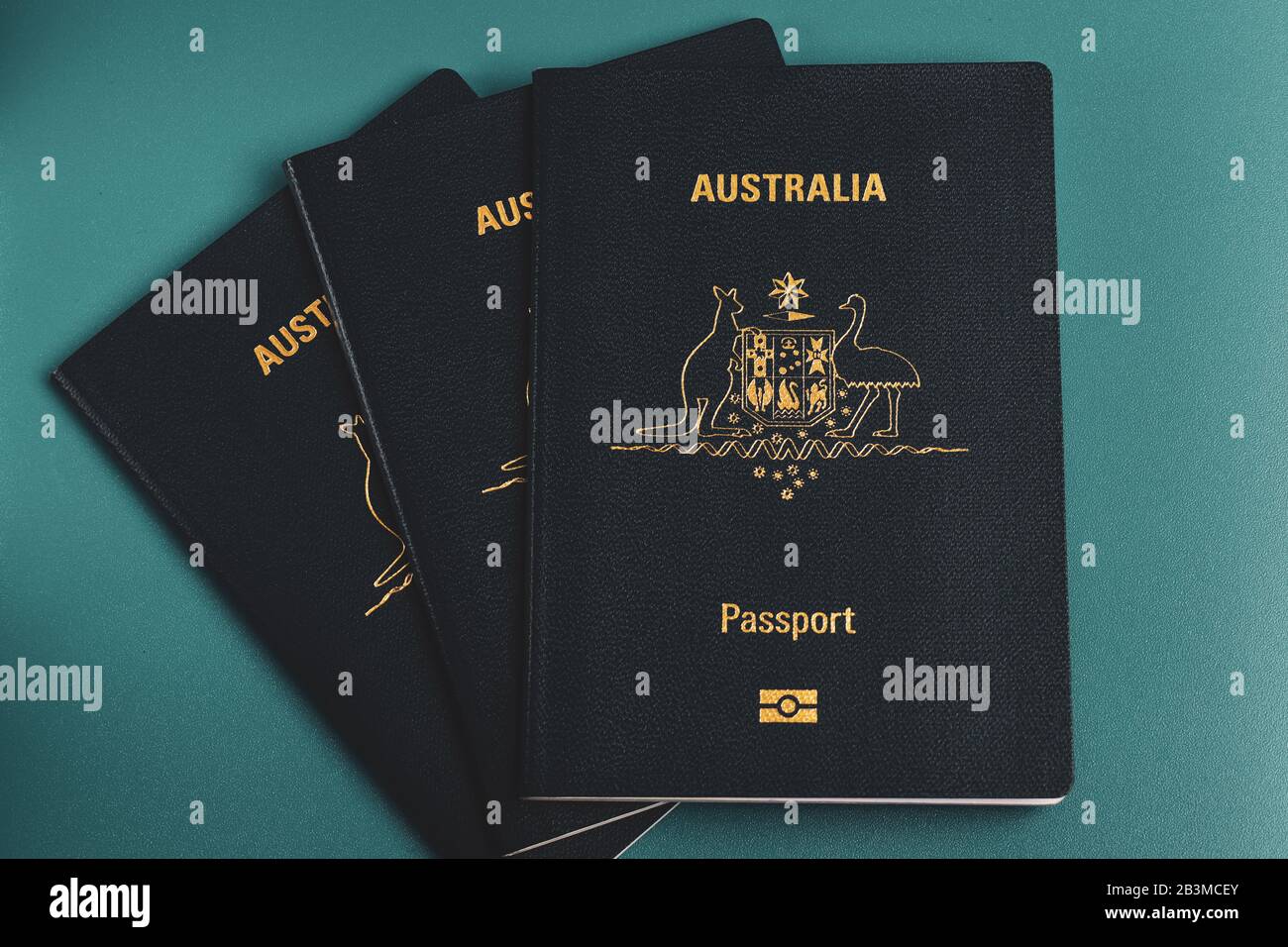 Three passports on top of each other from left to right with a light