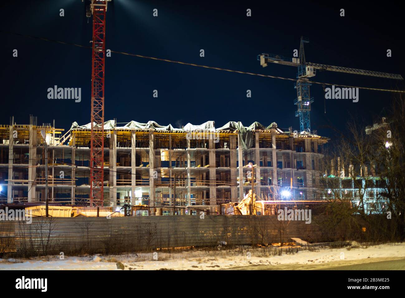 Night construction site at dusk. Construction crane in night ...