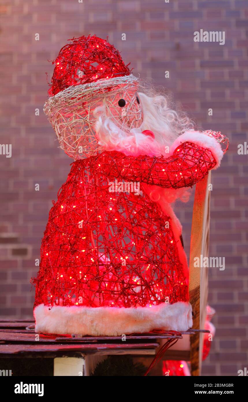 Christmas decoration Illuminated Santa Claus at dusk Stock Photo - Alamy