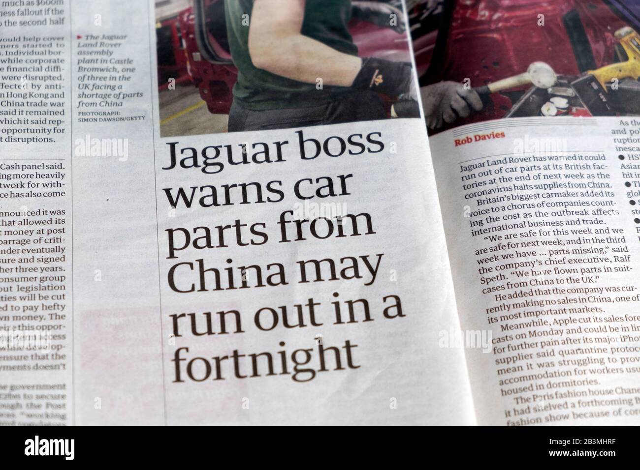 'Jaguar boss warns car parts from China may run out in a fortnight' coronavirus effect inside pages newspaper article in Guardian London England UK Stock Photo