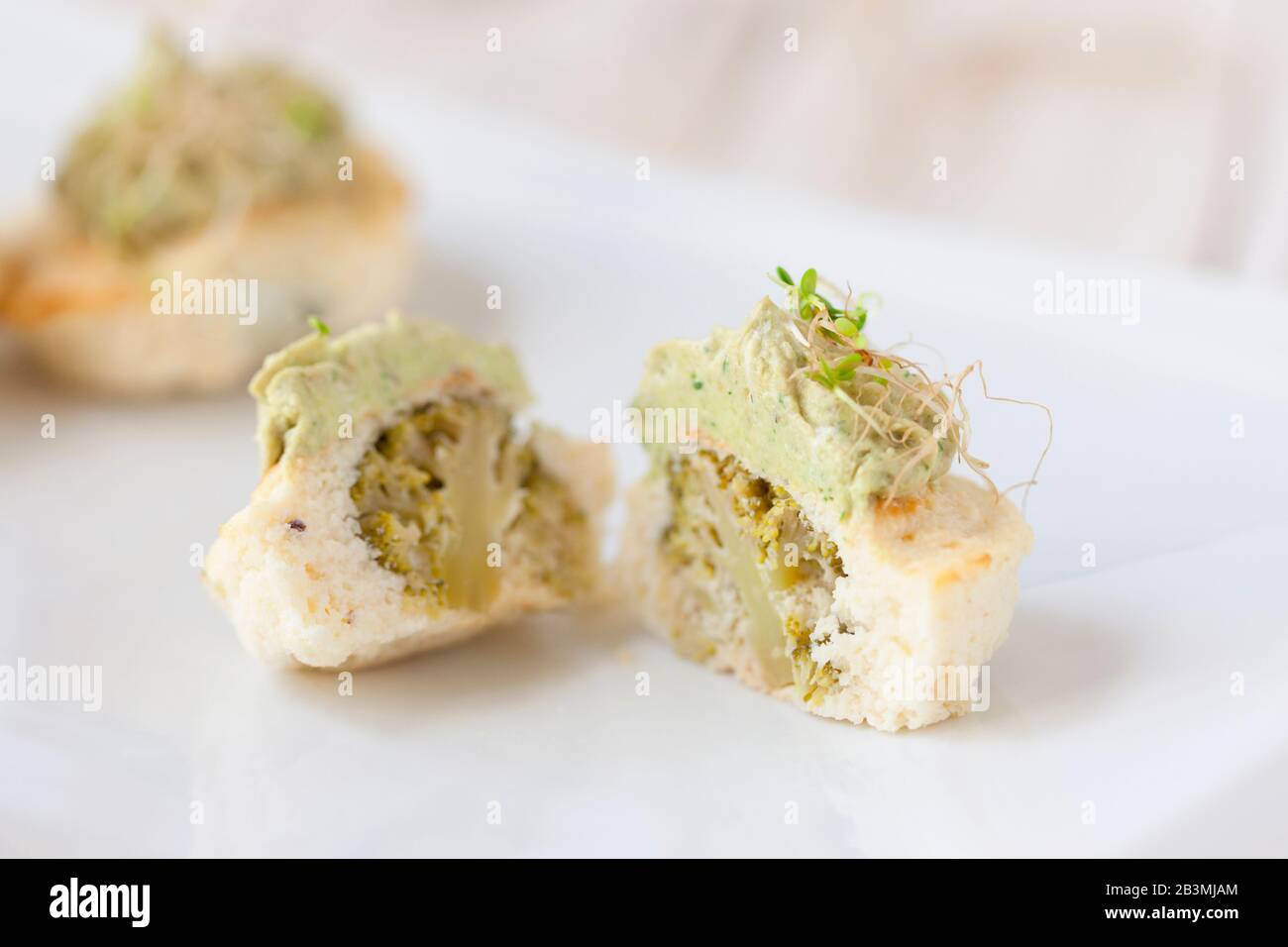 Mini cauliflower casseroles with avocado cream on a white plate Stock Photo