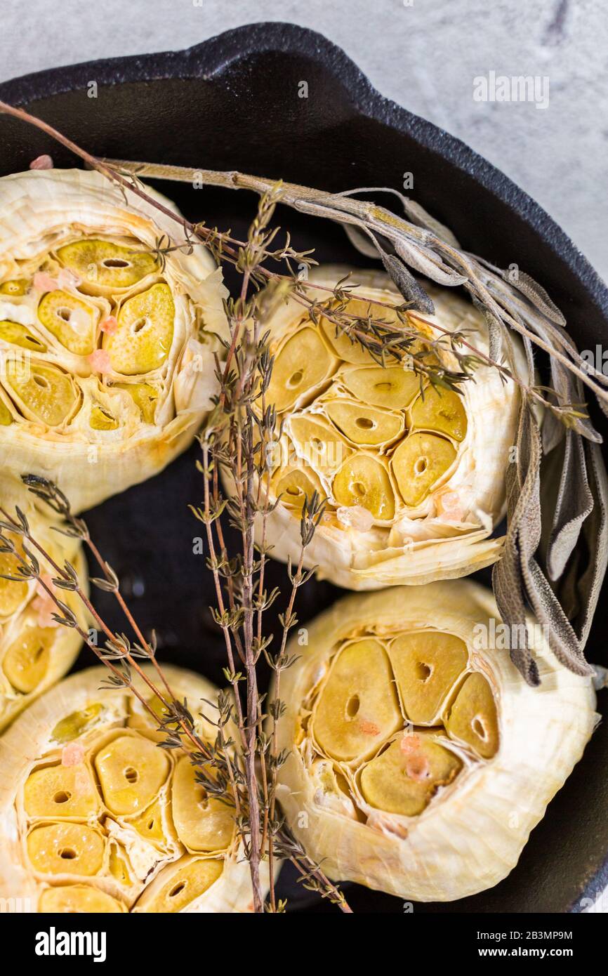 Roasted garlic spread recipe made with spices in cast iron skillet