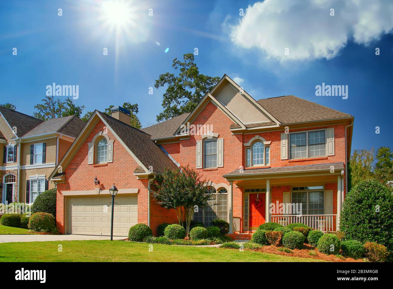 Nice Brick House with Sun Overhead Stock Photo - Alamy